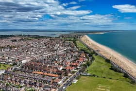 A view of the Southsea coastline heading towards Eastney with the the cricket pitch and the pitch and putt and Tenth Hole tearooms in the foreground.