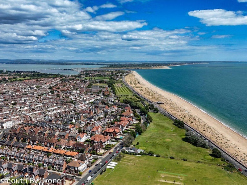 A view of the Southsea coastline heading towards Eastney with the the cricket pitch and the pitch and putt and Tenth Hole tearooms in the foreground.