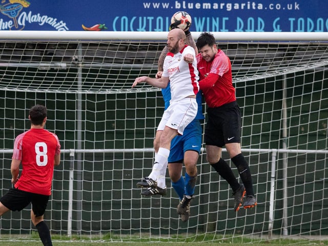 Fareham goalkeeper Luke Deacon catches despite the attentions of Horndean's Tom Jeffes. Picture: Keith Woodland