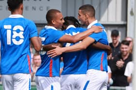 Triallist Gassan Ahadme celebrates scoring for Pompey against the Hawks with two other triallists. Picture: Paul Collins