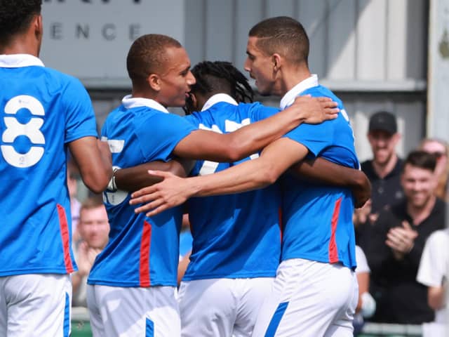 Triallist Gassan Ahadme celebrates scoring for Pompey against the Hawks with two other triallists. Picture: Paul Collins