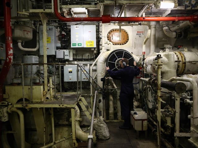 Crew member ETME Turnley seen working in the engine room onboard HMS Illustrious in May 10, 2013. Photo by Dan Kitwood/Getty Images