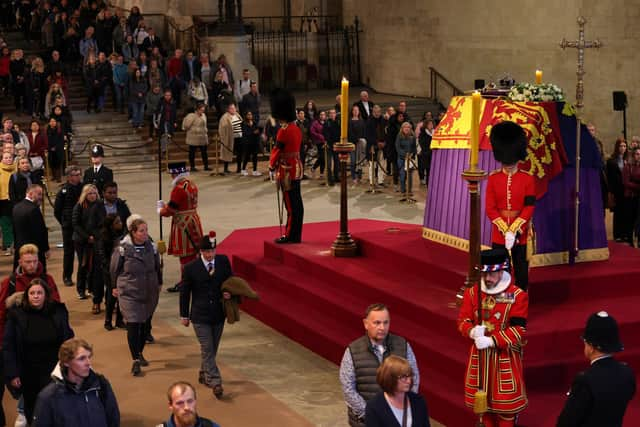 Members of the public view the coffin of Queen Elizabeth II, lying in state on the catafalque in Westminster Hall, at the Palace of Westminster, London, ahead of her funeral on Monday. Picture date: Sunday September 18, 2022. Picture: Adrian Dennis/PA.