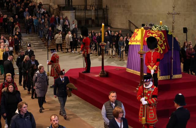 Members of the public view the coffin of Queen Elizabeth II, lying in state on the catafalque in Westminster Hall, at the Palace of Westminster, London, ahead of her funeral on Monday. Picture date: Sunday September 18, 2022. Picture: Adrian Dennis/PA.