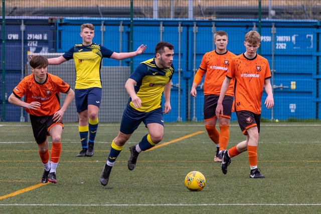 Action from the 2-2 draw between the under-18s of Moneyfields (blue/yellow kit) and AFC Portchester (orange/black kit). Picture: Mike Cooter