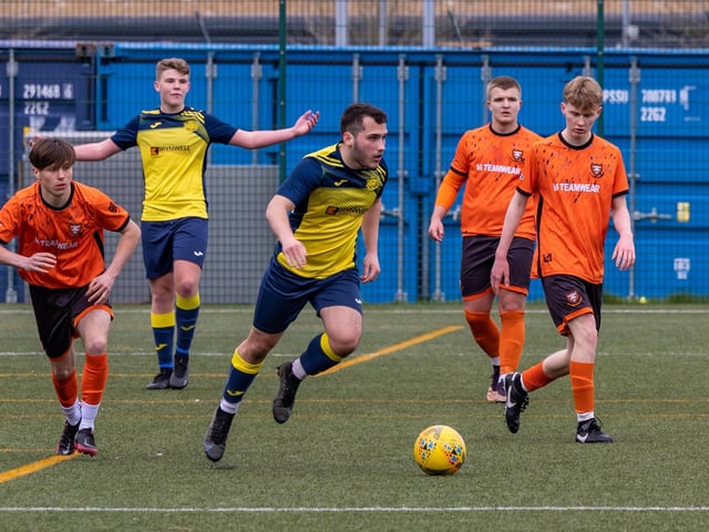Action from the 2-2 draw between the under-18s of Moneyfields (blue/yellow kit) and AFC Portchester (orange/black kit). Picture: Mike Cooter