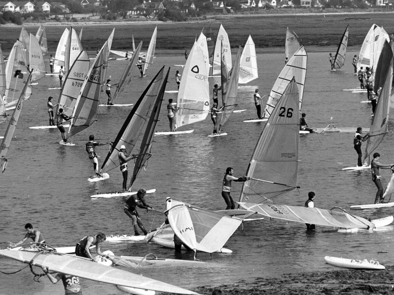 Windsurfers heading to the seas from Northney Marina, Hayling Island, 1988. The News PP5398