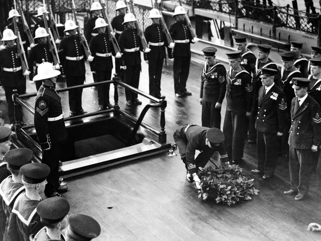 Victory Day At Portsmouth, The 132nd anniversary of Trafalger Day was celebrated with pomp at Portsmouth today. A wreath of laurels was laid upon the deck of H.M.S. victory on the spot where Nelson fell. - The wreath being laid on the spot where Nelson fell, Portsmouth. (Photo by Hulton Archive/Getty Images)