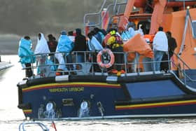 Around 140 migrants arrive in Portsmouth after being transferred from a single dingy south of the Isle of Wight in the English Channel by two RNLI lifeboats, a mammoth operation is talking place on Sunday evening to process the illegal migrants, with dozens of government workers from Police, Border Force, Ambulance and Fire crews, along with a number of transport busses. Viewed from Hayling Island, just across the water.  Dated 06/09/26.