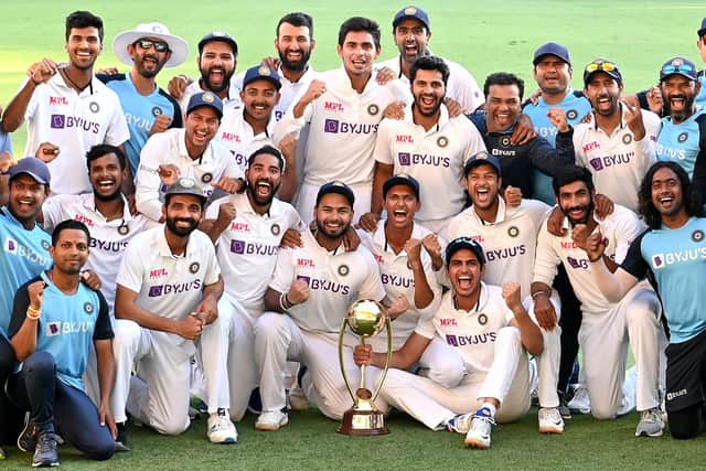 The Indian team celebrate after becoming the first side to beat Australia in a Test in Brisbane since 1988. Photo by Bradley Kanaris/Getty Images.