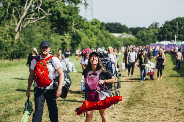 New arrivals walking on to the site on the opening day of Isle of Wight Festival 2022.