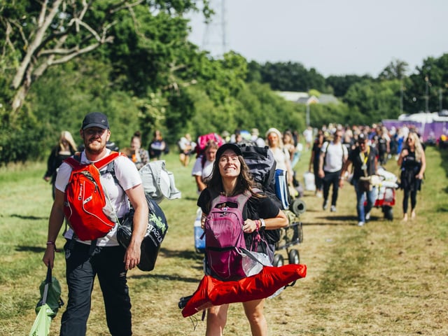 New arrivals walking on to the site on the opening day of Isle of Wight Festival 2022.