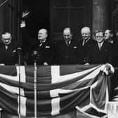 British Prime Minister Winston Churchill addresses the crowds from the balcony of the Ministry of Health in Whitehall on VE Day, on May 8, 1945. From left to right, Ernest Bevin, Churchill, Sir John Anderson, Lord Woolton and Herbert Morrison.  (Photo by Central Press/Hulton Archive/Getty Images)
