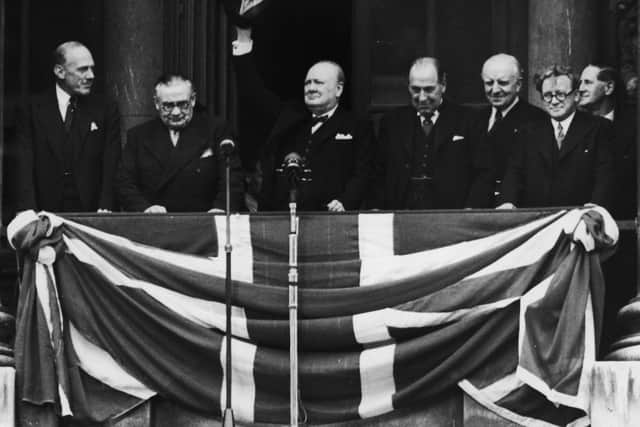 British Prime Minister Winston Churchill addresses the crowds from the balcony of the Ministry of Health in Whitehall on VE Day, on May 8, 1945. From left to right, Ernest Bevin, Churchill, Sir John Anderson, Lord Woolton and Herbert Morrison.  (Photo by Central Press/Hulton Archive/Getty Images)