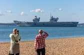 Onlookers at Southsea Beach watching HMS Prince Of Wales being deployed. Picture: Mike Cooter (280924)