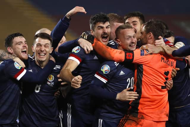 Goalkeeper David Marshall celebrates with his colleagues after his penalty save against Serbia sent Scotland through to their first major football finals since the 1998 World Cup. Photo by Srdjan Stevanovic/Getty Images.