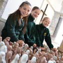 Pupils from St Matthew's C of E Primary School in Blackmoor, with some of the clay sculptures