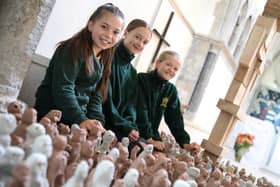 Pupils from St Matthew's C of E Primary School in Blackmoor, with some of the clay sculptures