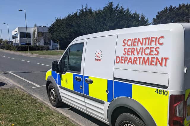 A Scientific Services Department vehicle parked along the road from the house that was targeted. Picture: Emily Turner