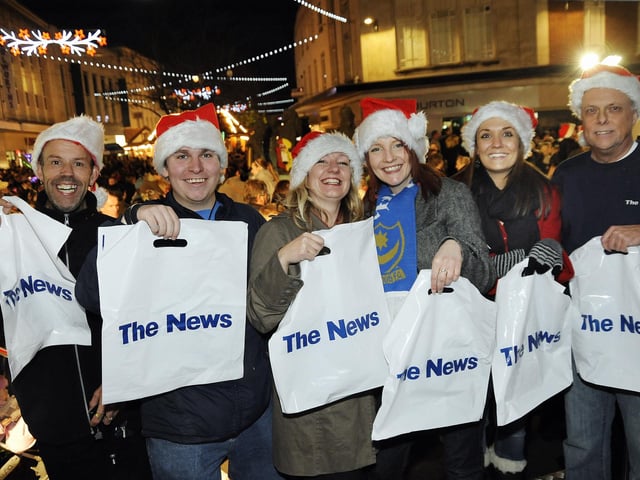 The News sellers and promotions team with their goodie bags, enjoying the Christmas lights show in Commercial Road, Portsmouth in 2008. Festive switch-on of the City Centre Christmas Lights in Commercial Road. Picture: Michael Scaddan (084638-0288)