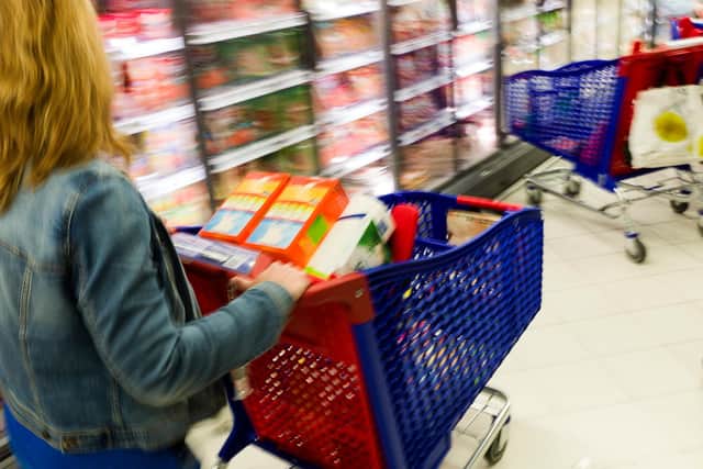 A customer pushes a shopping cart. Picture: FRED DUFOUR/AFP via Getty Images