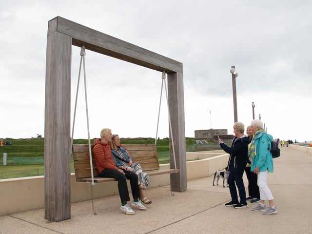 Local residents enjoy the new swing chairs along the promenadePicture: Habibur Rahman
