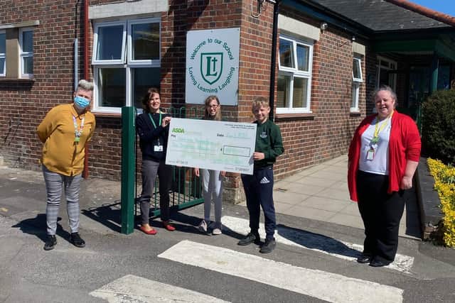 Leesland CE Federation had 10 laptops donated thanks to Gosport Asda, along with £2,000 in grants from the Asda Foundation. Pictured: Asda store manager Catherine Curtis, associate head teacher Anne Wake with pupils Jack and Annabelle, and community champion Rachel Webber