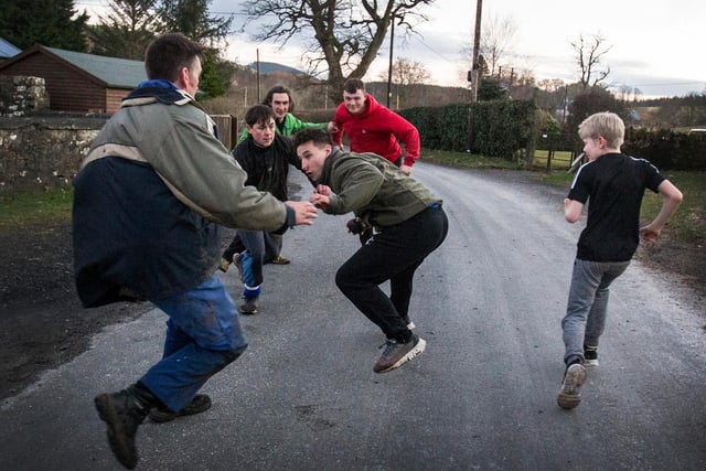 Richard Jackson and John Fishwick at The Hobkirk Hand Ba' trying to catch Grant Huggan. Photo: Bill McBurnie