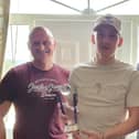 Ronan Curtis collects his prize from Pompey Northern Ireland Supporterts' club chairman Bob Woolley, right, and marketing manager James Attwood, left.