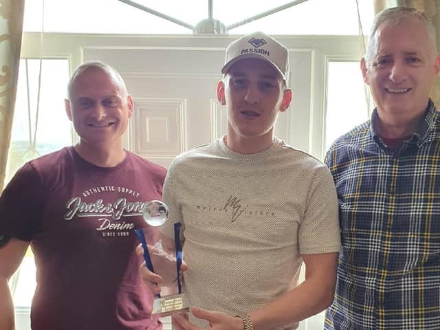 Ronan Curtis collects his prize from Pompey Northern Ireland Supporterts' club chairman Bob Woolley, right, and marketing manager James Attwood, left.