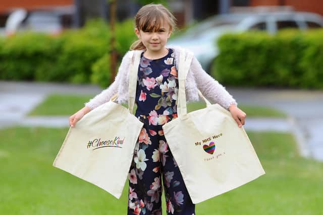 Sofia Dennis (8) from Swanmore, with her canvas bags she has been making and selling to raise money for NHS Charities Together. Picture: Sarah Standing (290420-1227)