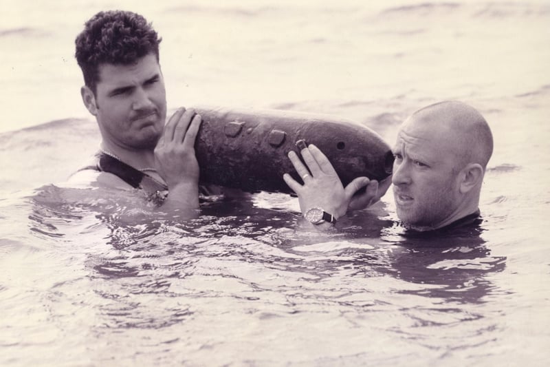AB diver Garry Nicholas-Horvarth-Toldi (left) and AB diver Neil Smith, lift a WW2 defused bomb out the Solent, 1995. The News PP5544