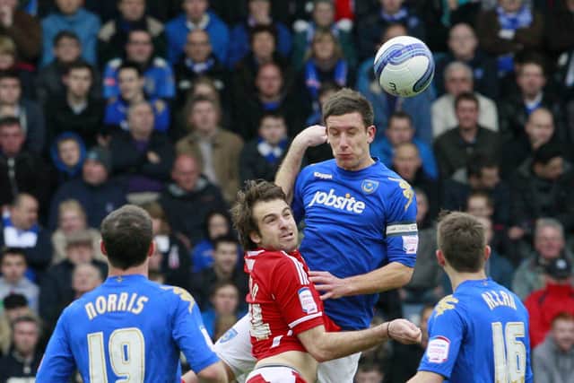 Jason Pearce rises above Brett Pitman during a March 2012 encounter with Bristol City at Fratton Park. Picture: Barry Zee