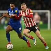 Cardiff's Curtis Nelson, left, challenges Sheffield United's Oli McBurnie Pic: Ashley Crowden/Sportimage