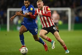 Cardiff's Curtis Nelson, left, challenges Sheffield United's Oli McBurnie Pic: Ashley Crowden/Sportimage