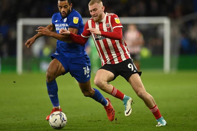 Cardiff's Curtis Nelson, left, challenges Sheffield United's Oli McBurnie Pic: Ashley Crowden/Sportimage