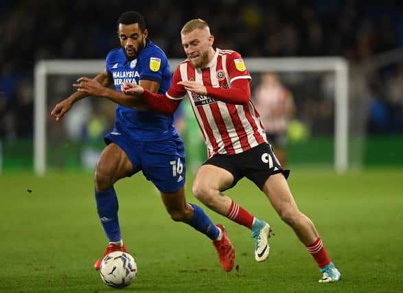 Cardiff's Curtis Nelson, left, challenges Sheffield United's Oli McBurnie Pic: Ashley Crowden/Sportimage