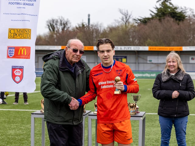 Oakley Gouge receives the player of the match award from John Carter, chairman of the Portsmouth Youth Football League. Picture: Mike Cooter