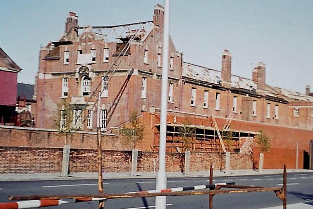 Buildings from the original 1906 RN Barracks, looking from Unicorn Road, being demolished. Part of the new Unicorn Gate can be seen on the far right.