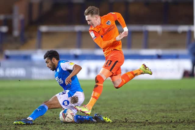 Ronan Curtis battles with Nathan Thompson during the 1-0 defeat at Peterborough - with Joe Gallen praising the Pompey commitment. Picture: Nigel Keene/ProSportsImages