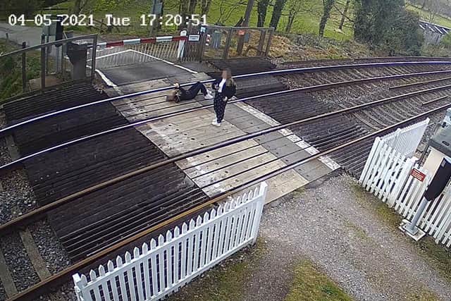 Girl pictured lying down on railway tracks near Horsham. Picture: Network Rail