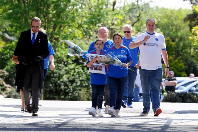 Devoted dad and Pompey fan Dominic Merrix died suddenly after appearing to recover from Covid-19. Pictured are his daughter. Ellie-Mai, 10, and partner Sarah as they arrive at Portchester Crematorium holding flowers. 
Picture: Sarah Standing (270420-1120)