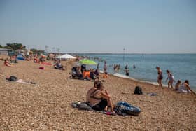 People enjoying some fine weather on Southsea Beach.