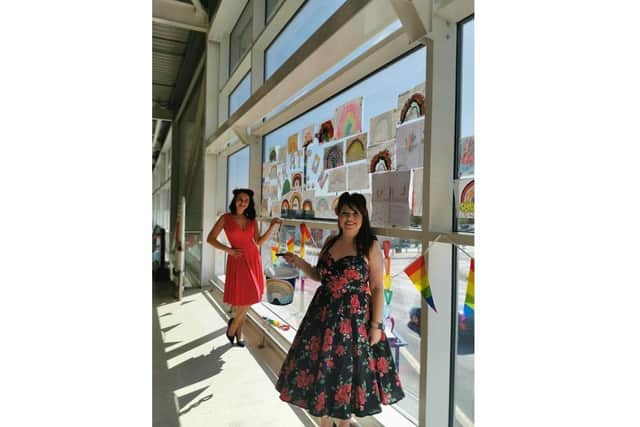 Fratton Tesco held a fundraiser for the NHS and two-year-old George McGowan, who boosted the total by selling toys, was invited to hand the cheque over to Queen Alexandra Hospital. Pictured: Two colleagues who sang instore for the day with the rainbow images