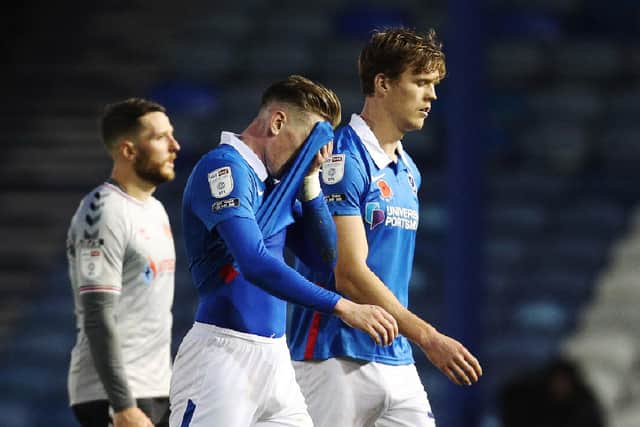 Ronan Curtis and Sean Raggett walk off dejected after Pompey's loss to Charlton. Picture: Joe Pepler