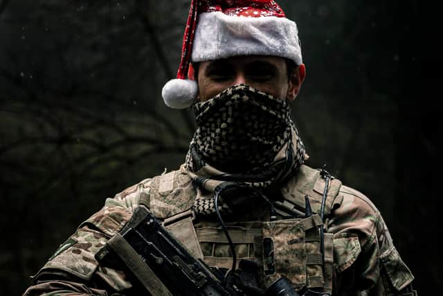 A Soldier from 4 PWRR poses for a photo after an early morning attack followed by their Christmas meal, keeping his festive spirit going. 
Photo: Sgt Nick Johns RLC / MoD Crown