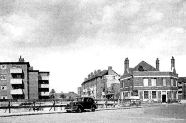 With a bomb site on the left, this is the top of North Street, Portsea. The Duke of Edinburgh pub is on the right.