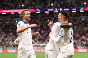 Bukayo Saka celebrates with Harry Kane and Phil Foden after scoring England's third goal against Senegal (Photo by Catherine Ivill/Getty Images)