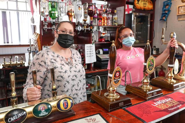 Landlady Katie Jones pictured behind the bar with Elisha Palmer. Picture: Stuart Martin (220421-7042)