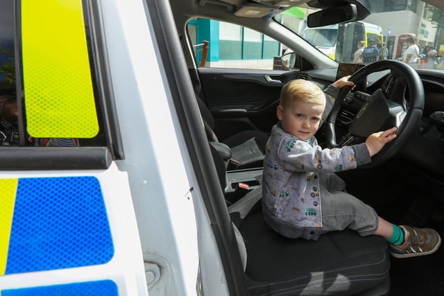 Wilfred Faull, 2, took his chance to sit at the wheel of a police car. Picture: Chris Moorhouse (220624-02)